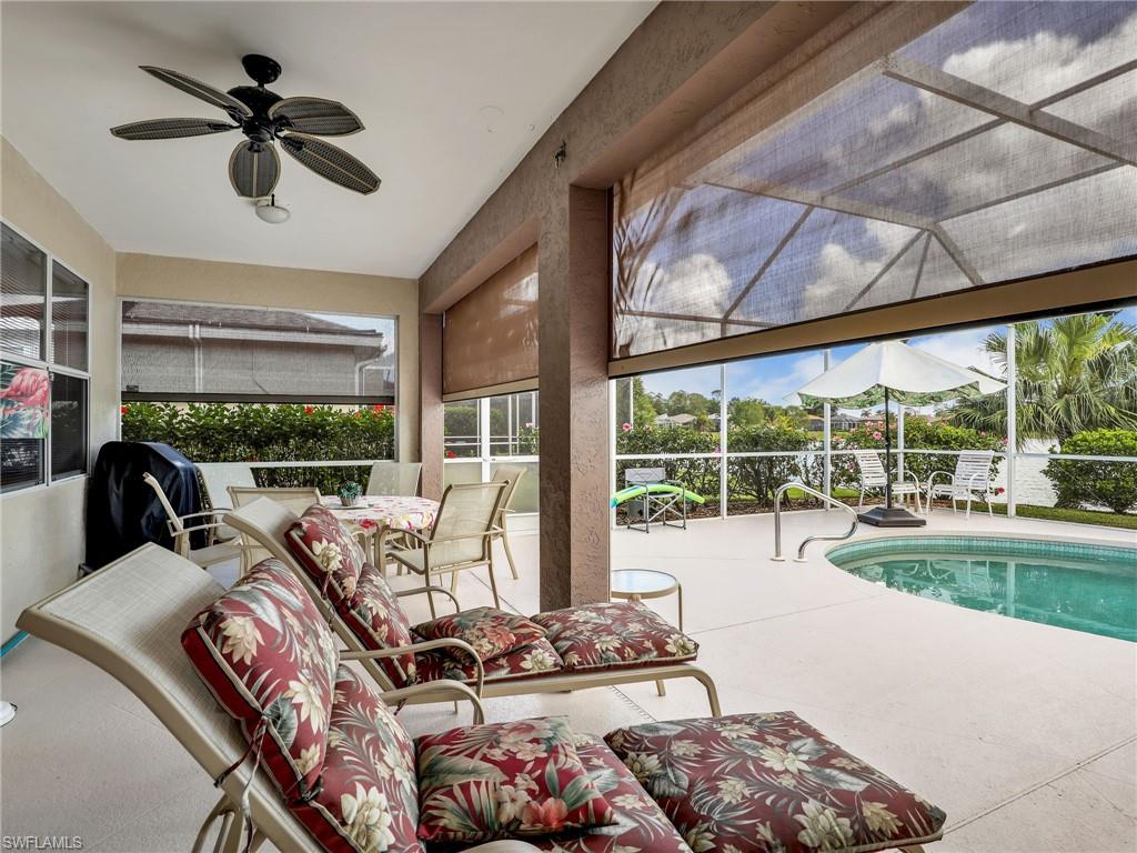 586 Crossfield Circle Naples, FL 34104 - Photo 21 of 38 a living room with furniture and a large window