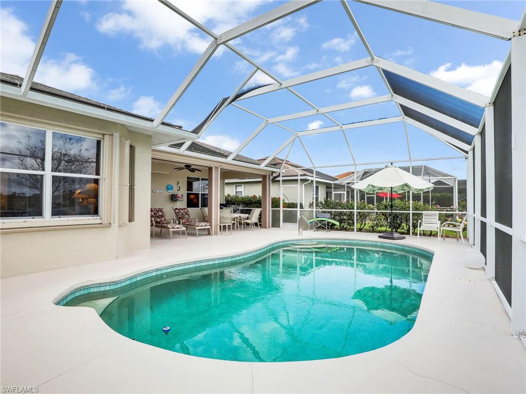 586 Crossfield Circle Naples, FL 34104 - Photo 24 of 38 a swimming pool with outdoor seating yard and patio