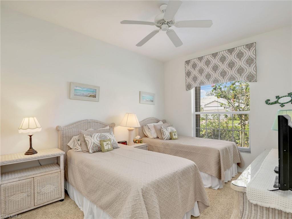 586 Crossfield Circle Naples, FL 34104 - Photo 26 of 38 a bedroom with a bed and a flat screen tv