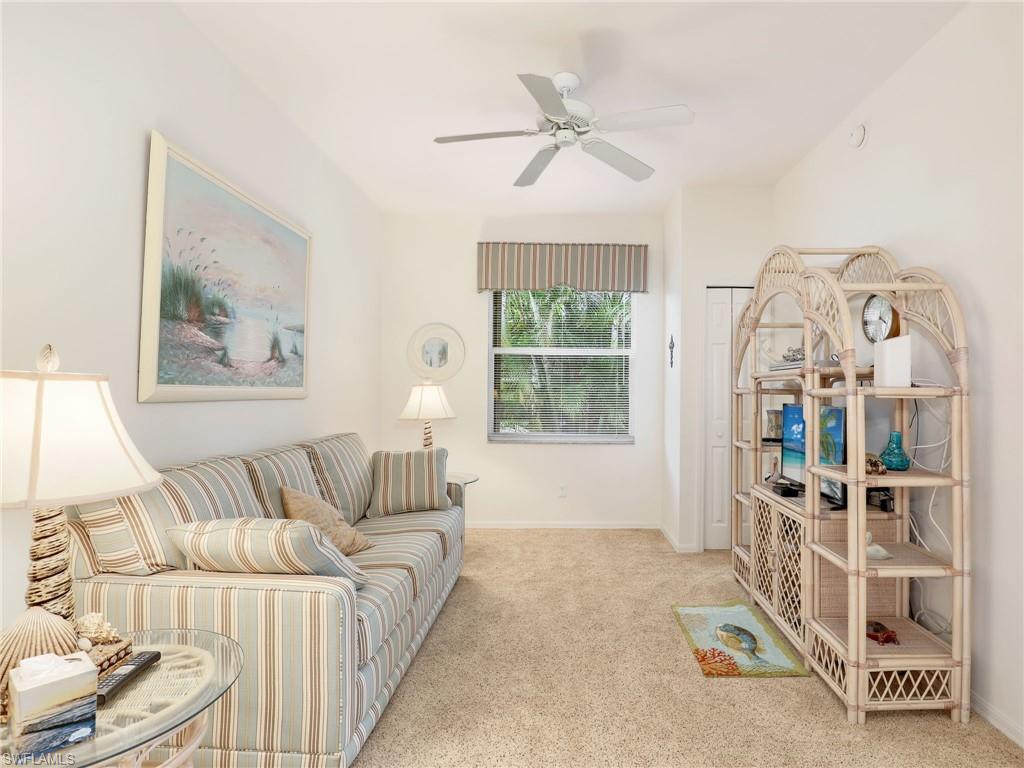 586 Crossfield Circle Naples, FL 34104 - Photo 29 of 38 a living room with furniture and a large window