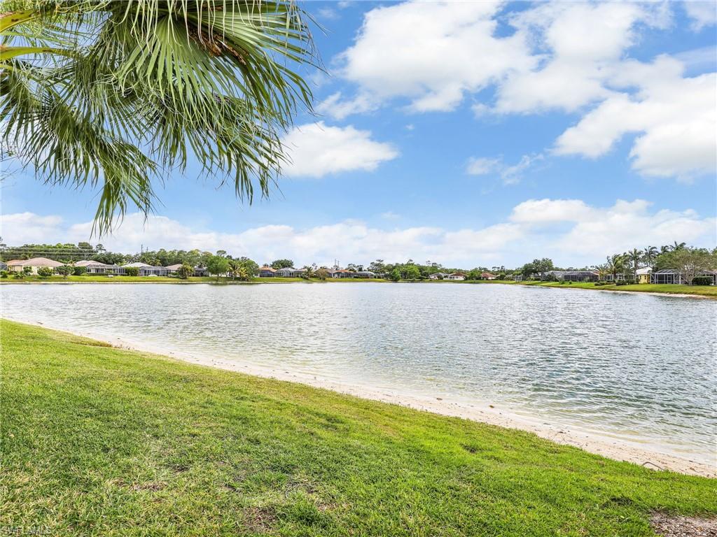 586 Crossfield Circle Naples, FL 34104 - Photo 32 of 38 a view of a lake from a yard