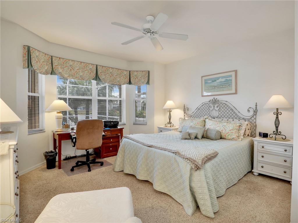 586 Crossfield Circle Naples, FL 34104 - Photo 4 of 38 a bedroom with bed and chair