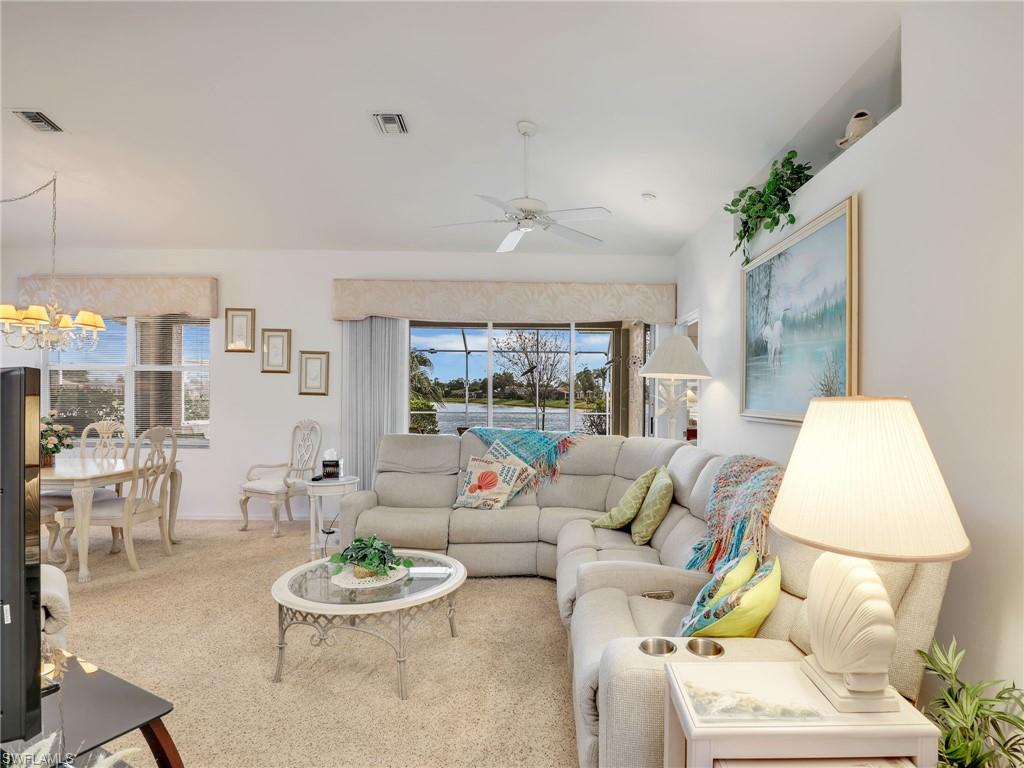 586 Crossfield Circle Naples, FL 34104 - Photo 5 of 38 a living room with furniture and a wooden floor