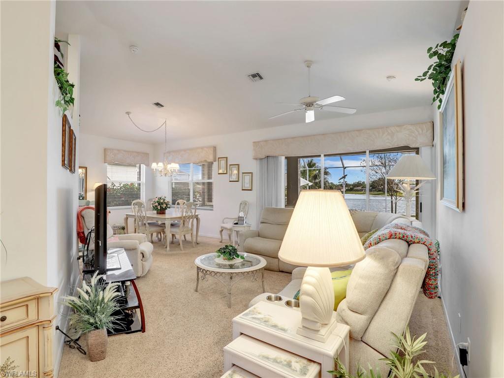 586 Crossfield Circle Naples, FL 34104 - Photo 9 of 38 a living room with furniture and a table