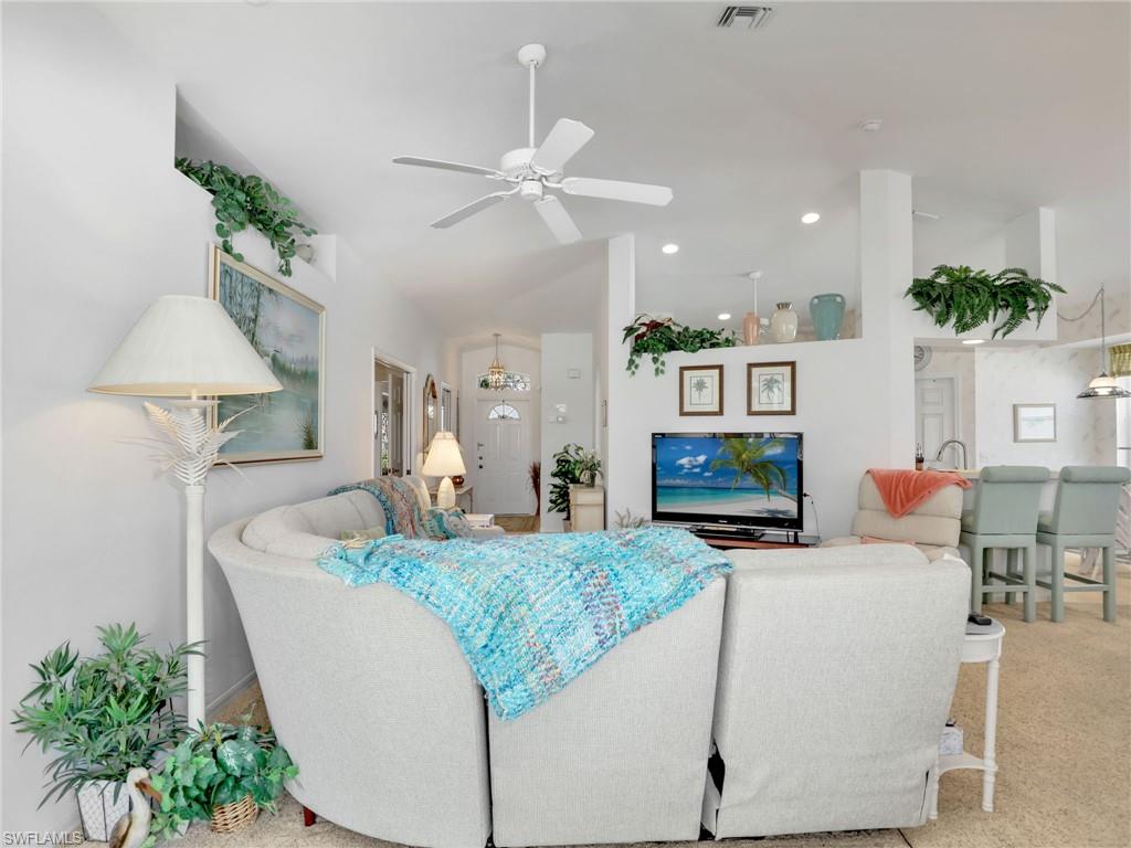 586 Crossfield Circle Naples, FL 34104 - Photo 10 of 38 a living room with furniture and a chandelier