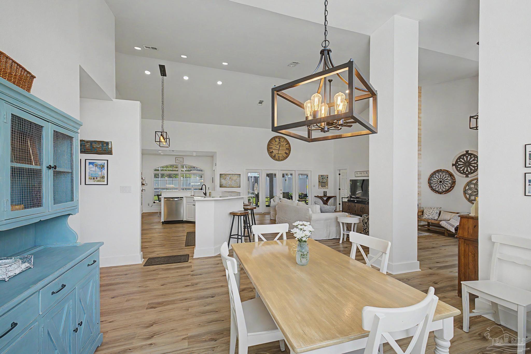 2005 Riviera Lane South Navarre, FL 32566 - Photo 8 of 70 a dining room with wooden floor a glass table and chairs