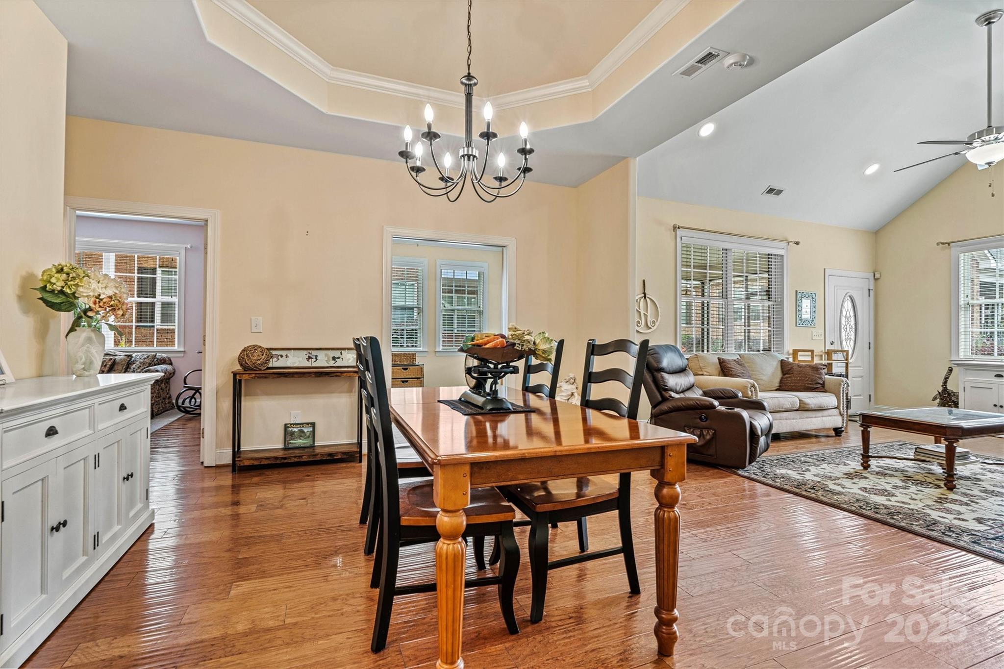 2369 Stardust Court Denver, NC 28037 - Photo 17 of 42 a view of a dining room with furniture a chandelier and wooden floor