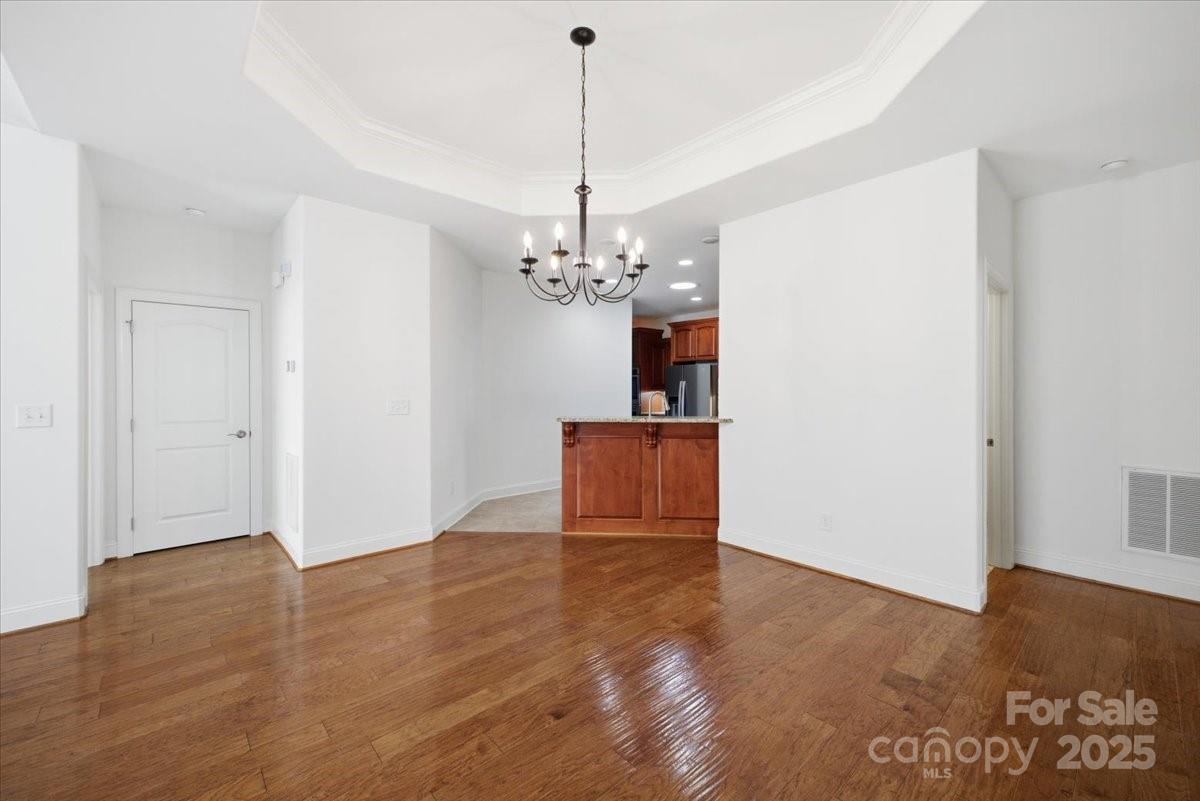 2369 Stardust Court Denver, NC 28037 - Photo 17 of 47 a view of a room with wooden floor chandelier and windows