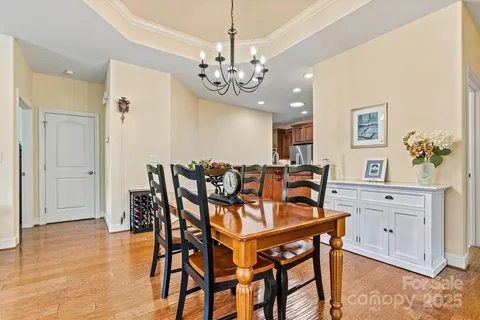 a view of a dining room with furniture and chandelier