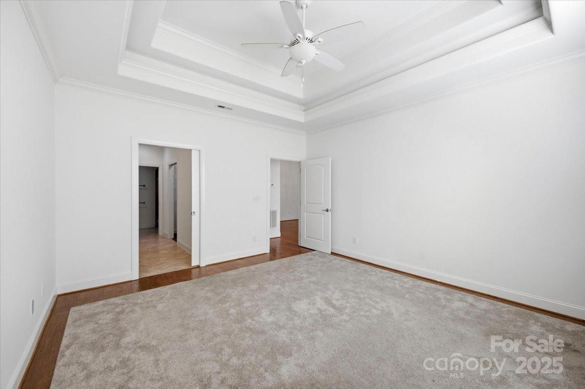 2369 Stardust Court Denver, NC 28037 - Photo 28 of 47 an empty room with a ceiling fan and carpet