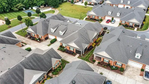 an aerial view of residential houses with outdoor space