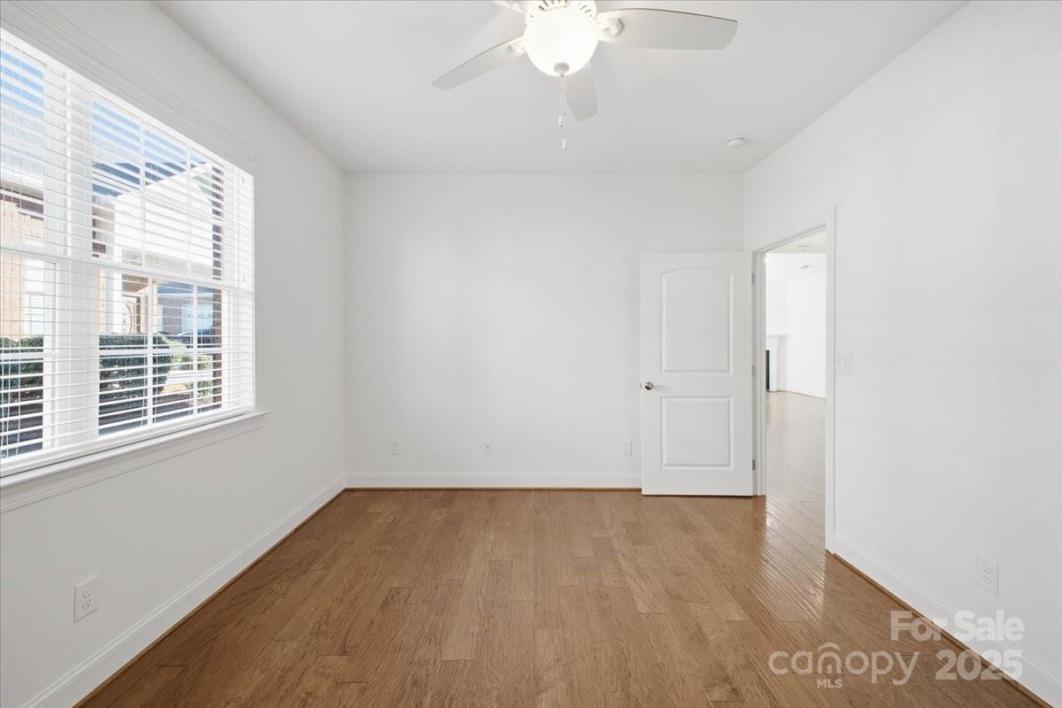 2369 Stardust Court Denver, NC 28037 - Photo 40 of 47 an empty room with wooden floor and windows