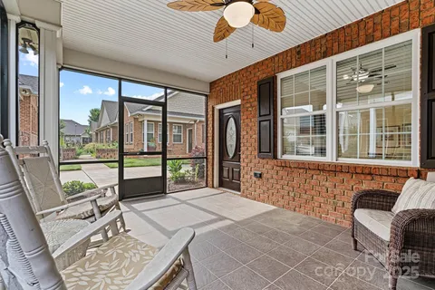 a bedroom with furniture and large windows