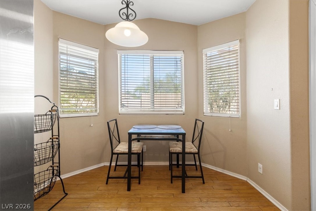 2377 Ramsgate Drive Henderson, NV 89074 - Photo 8 of 25 A cozy eat-in kitchen area features natural wood flooring and ample natural illumination from multiple windows.