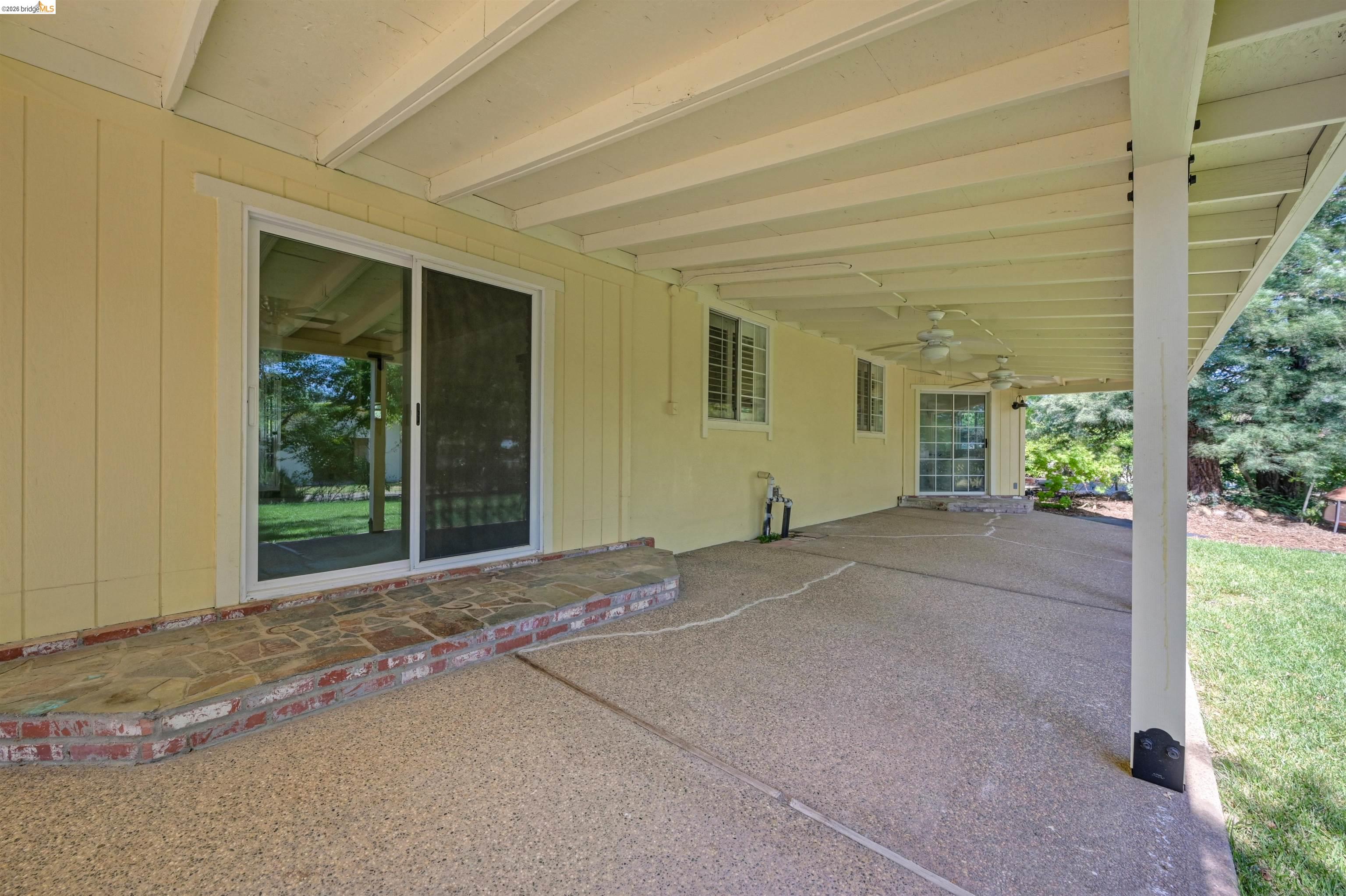 10474 Sheldon Road Elk Grove, CA 95624 - Photo 49 of 83 Expansive covered patio with exposed aggregate concrete flooring and multiple ceiling fans