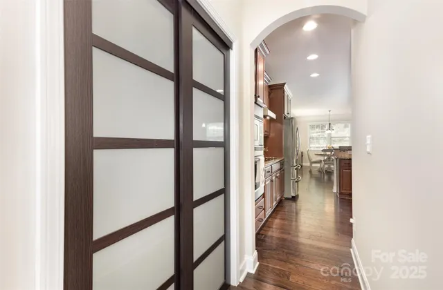 a view of a hallway view with wooden floor and staircase