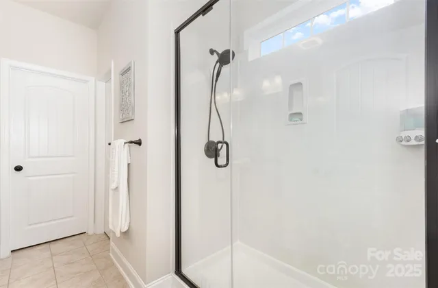 a bathroom with a glass shower door