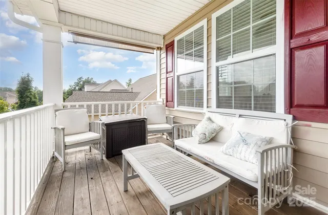 a balcony with furniture and a window