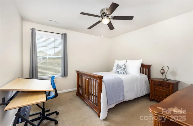 a bedroom with a bed chair and a window