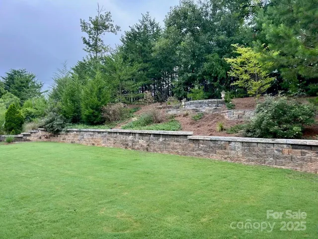 a view of a yard with large trees