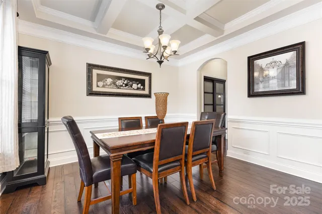 a view of a dining room with furniture wooden floor and a chandelier