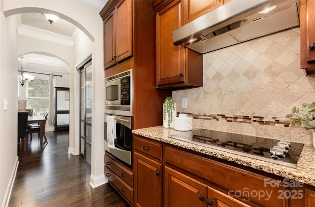 a kitchen with stainless steel appliances granite countertop a stove and a refrigerator