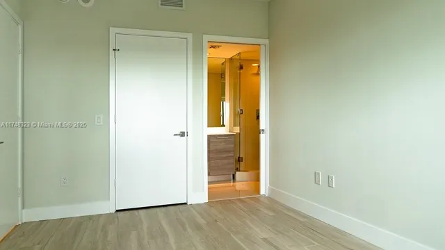 a bathroom with a granite countertop sink a toilet and a mirror