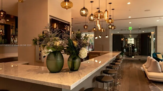 a view of a pathway with plants and large trees