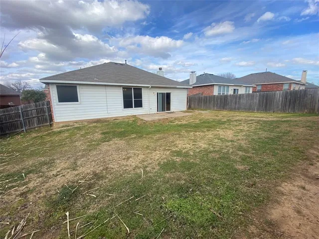 a front view of house with yard and mountain view in back