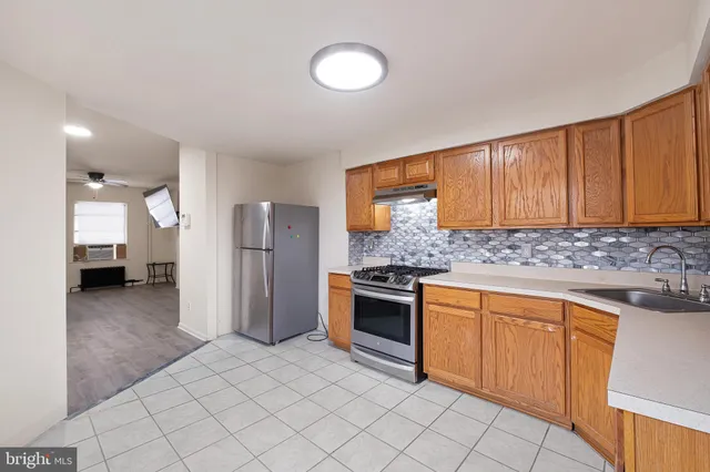 a kitchen with stainless steel appliances granite countertop a refrigerator and a sink