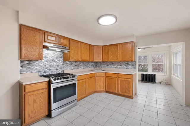 a kitchen with a stove sink and cabinets
