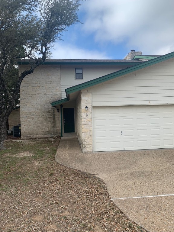 3300 Pinnacle Cove, Unit 3 Lago Vista, TX 78645 - Photo 1 of 1 a front view of a house with a garage