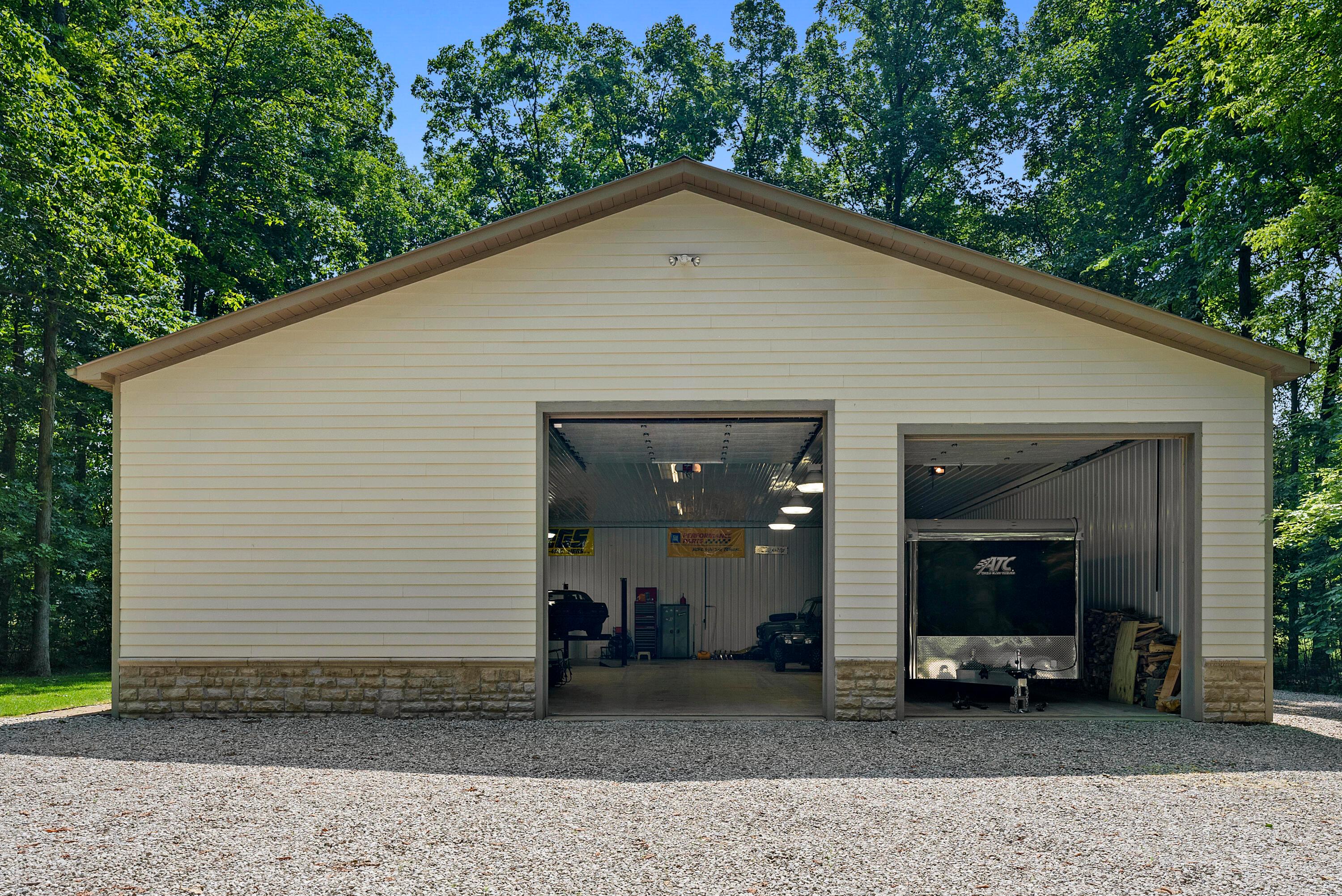 5761 Hughes Road Galena, OH 43021 - Photo 36 of 43 Expansive, Amish-built 60 x 48 multi-purpose building with metal walls and roof, Hardie Plank & stone front, and 13’ & 14’ overhead doors