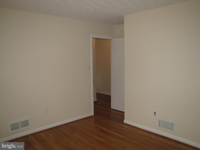 15411 Bond Mill Road Laurel, MD 20707 - Photo 2 of 26 a view of an empty room with wooden floor
