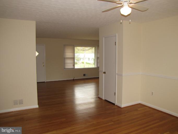 15411 Bond Mill Road Laurel, MD 20707 - Photo 15 of 26 an empty room with wooden floor and windows