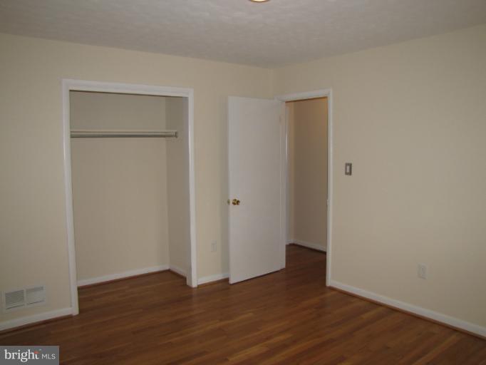 15411 Bond Mill Road Laurel, MD 20707 - Photo 16 of 26 a view of an empty room with wooden floor and closet