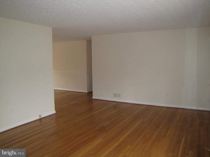 15411 Bond Mill Road Laurel, MD 20707 - Photo 19 of 26 a view of an empty room with wooden floor