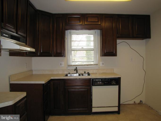 15411 Bond Mill Road Laurel, MD 20707 - Photo 20 of 26 a kitchen with a sink and cabinets