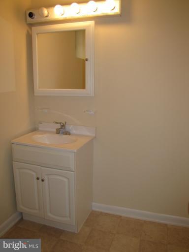 15411 Bond Mill Road Laurel, MD 20707 - Photo 3 of 26 a bathroom with a sink and a mirror