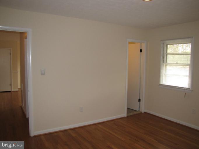15411 Bond Mill Road Laurel, MD 20707 - Photo 24 of 26 a view of an empty room with wooden floor and a window