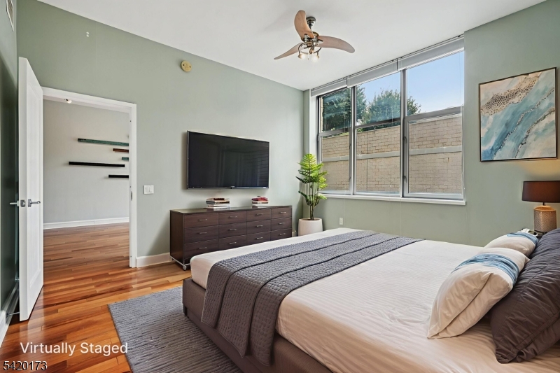 8100 River Road, Unit 210 North Bergen, NJ 07047 - Photo 13 of 25 a bedroom with a bed and a flat screen tv