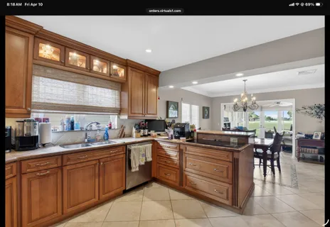 a kitchen that has a lot of cabinets in it and stainless steel appliances