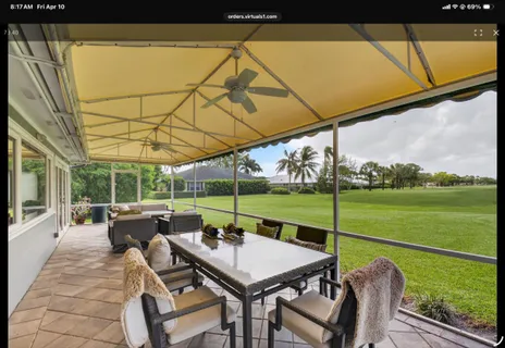 a view of a patio with a table chairs and a backyard