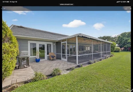 a view of a house with backyard and sitting area
