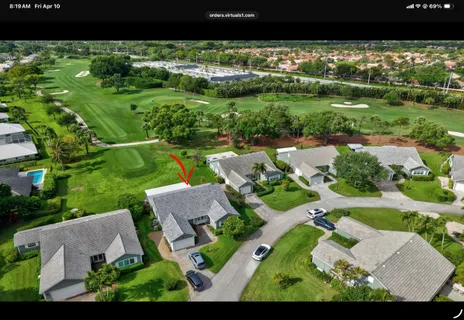 an aerial view of residential houses with outdoor space and street view