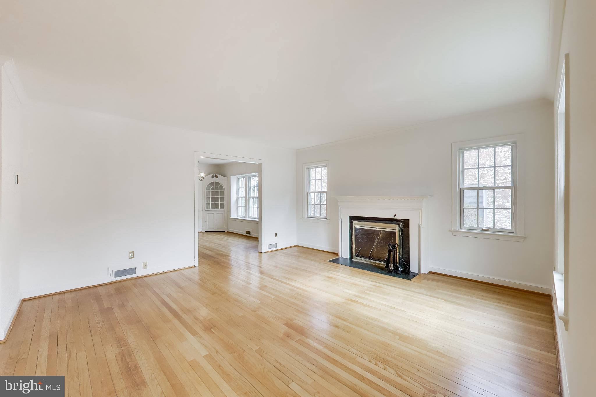 5138 Nebraska Avenue Northwest Washington, DC 20008 - Photo 5 of 39 an empty room with windows fireplace and windows