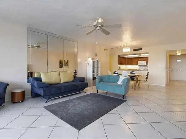 a kitchen with stainless steel appliances kitchen island granite countertop a sink and a dining table