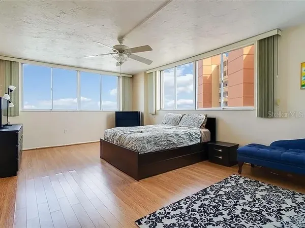 a kitchen with a stove a refrigerator and cabinets