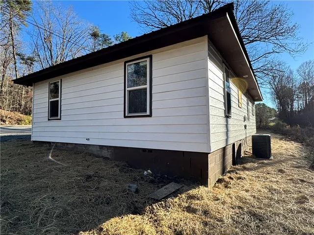 a backyard of a house with wooden fence and roof