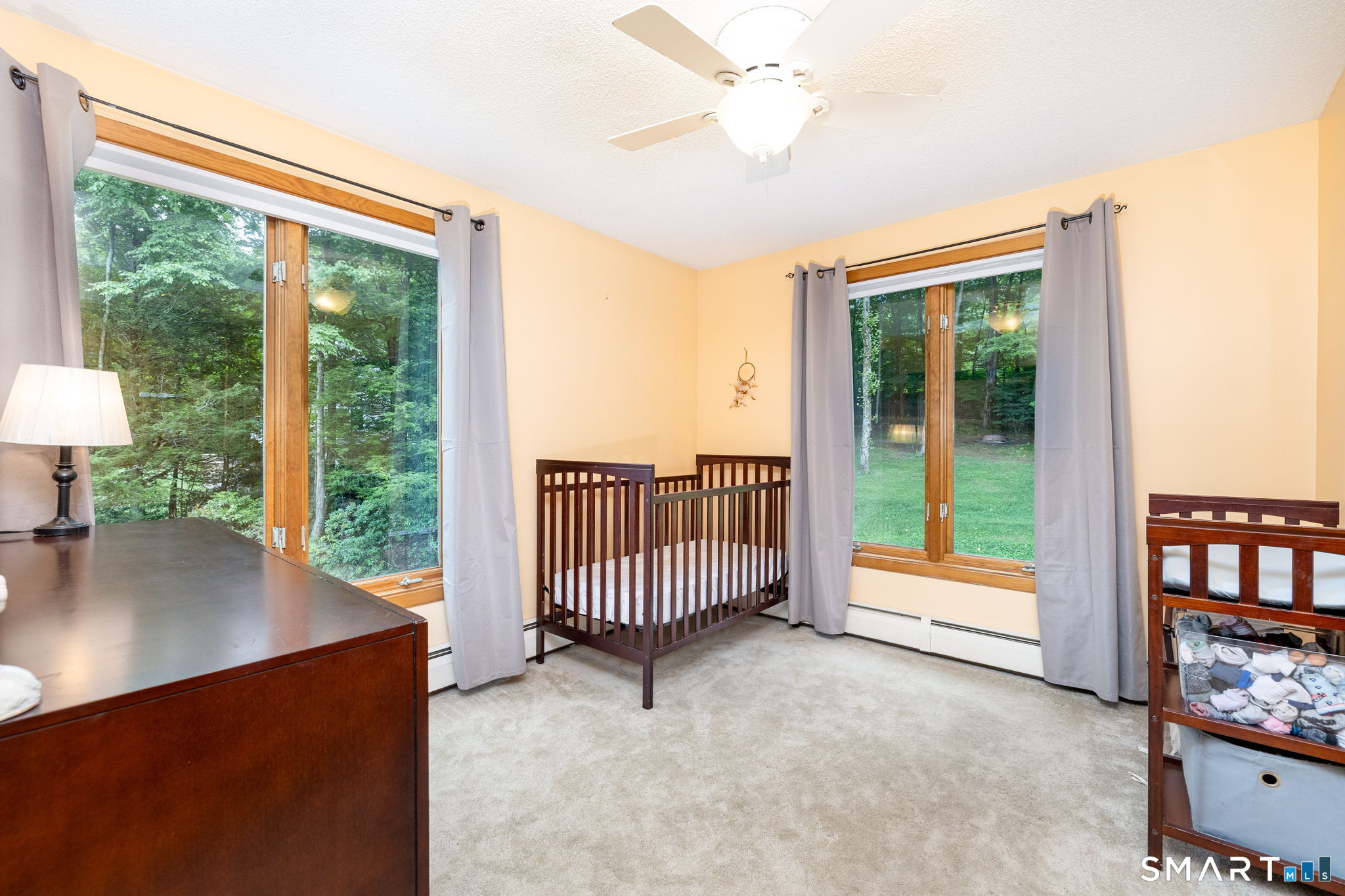 1386 Cedar Swamp Road Coventry, CT 06238 - Photo 22 of 39 Bright and cheerful bedroom filled with natural light, offering a warm and inviting space to relax and unwind.